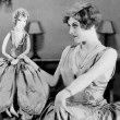 1928. Publicity at home with lookalike boudoir doll.