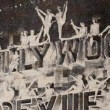 June 20, 1929. Three shots at the Grauman's Theater premiere of 'Hollywood Revue of 1929.' With live girls on the billboard.