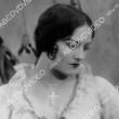 Two heavily watermarked photos of film stills with Joan from 'Tide of Empire.'