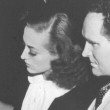 1938. Joan and director Frank Borzage on set.