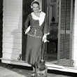 1931. On the set of 'This Modern Age' with dressing room and dog 'Woggles,' both gifts from husband Doug Fairbanks, Jr. (includes press caption).