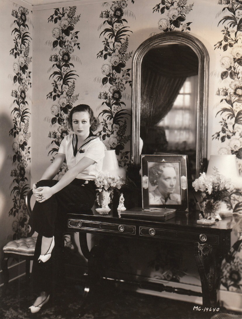 1931, in her dressing room, shot by Hurrell. With photo of Marlene Dietrich.