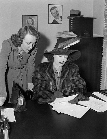 March 1939. Signing divorce papers.