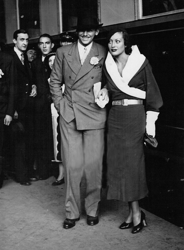 July 1932. With husband Doug Fairbanks, Jr., at London's Victoria Station.
