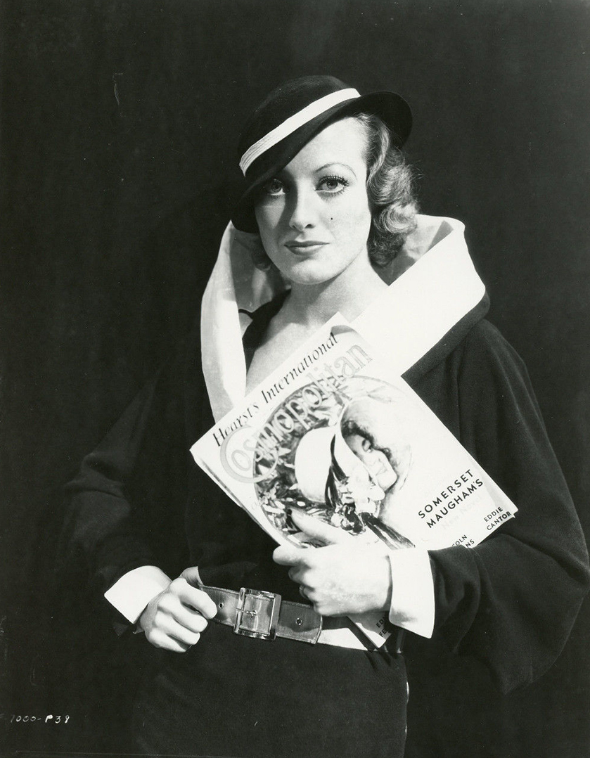 1932. Early publicity for 'Rain,' posing with an October 1932 issue of 'Cosmopolitan' featuring author Maugham.