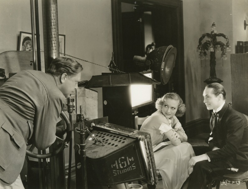 1933. On the set of 'Dancing Lady' with director Robert Z. Leonard and Franchot Tone.