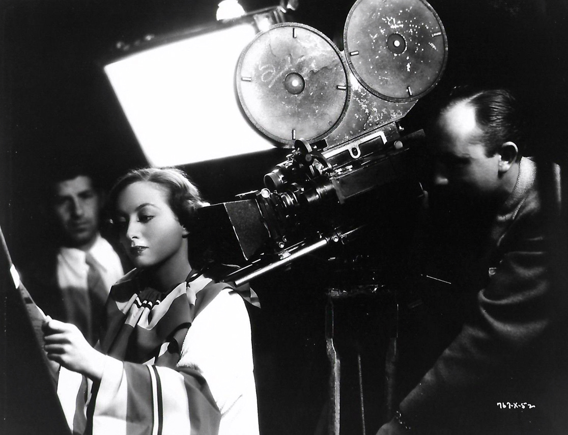 1934. 'Chained.' On the set with director Clarence Brown.