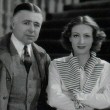 1934. On the 'Sadie McKee' set with director Brown, left, and unknown.