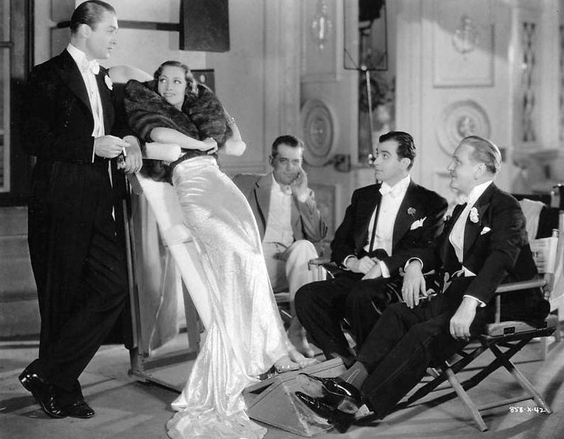 1935. On the set of 'I Live My Life' with Brian Aherne, et al.