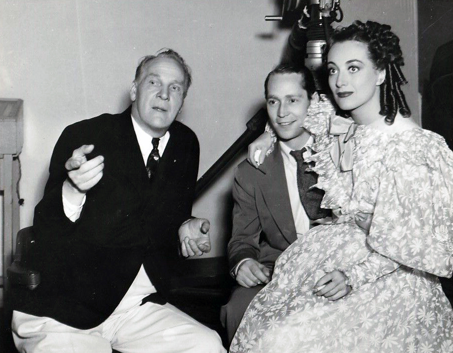 1936. On the set of 'The Gorgeous Hussy' with husband Franchot Tone, right.