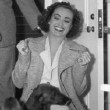 1937. In her dressing room with pups and Franchot.