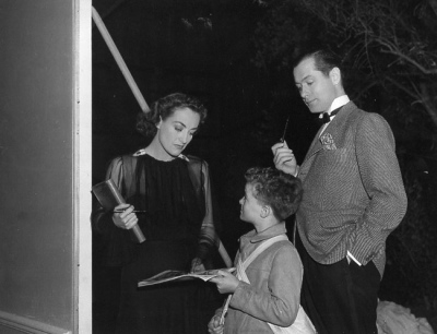 1937. On the set of 'Last of Mrs. Cheyney.' With Robert Montgomery, right.