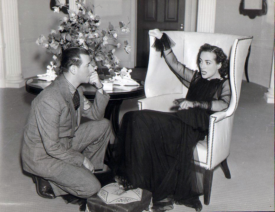 1937. On the set of 'The Last of Mrs. Cheyney' with designer Adrian.