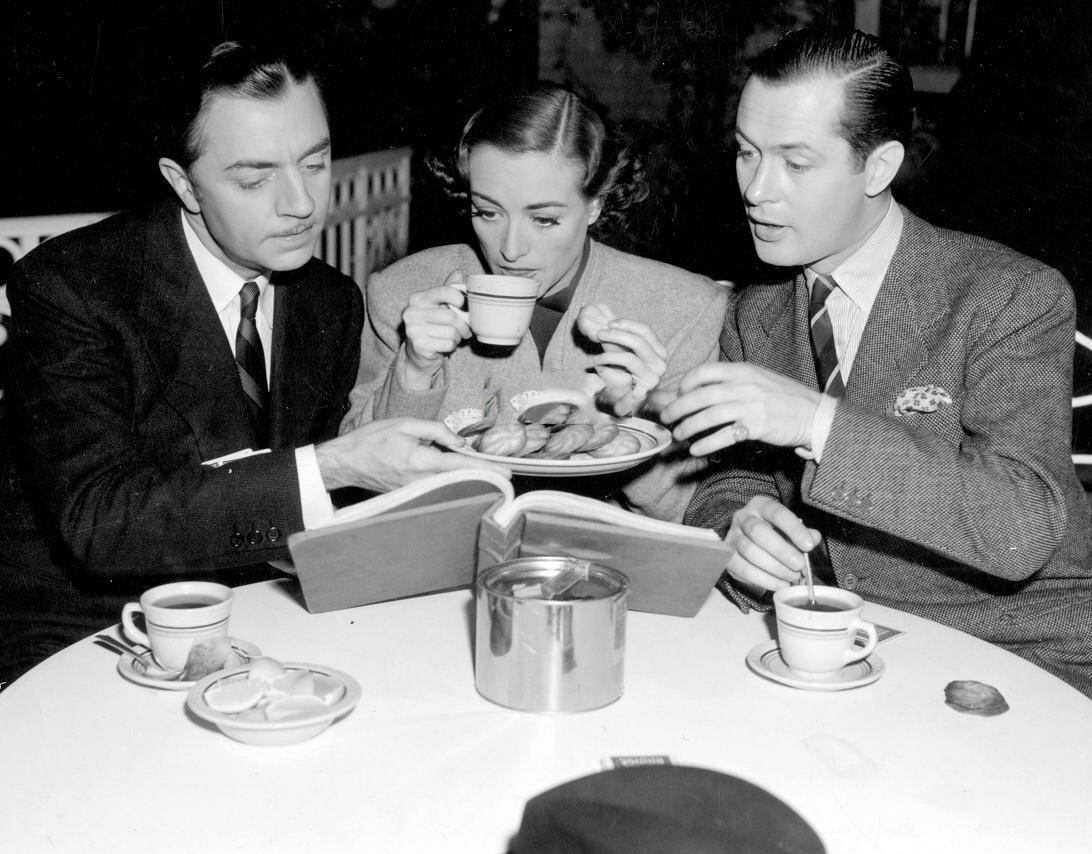 1937. On the set of 'The Last of Mrs. Cheynyey' with William Powell, left, and Robert Montgomery.