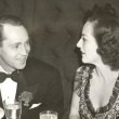 March '39. With Franchot Tone in NYC, celebrating the eve of their divorce. Includes press caption.