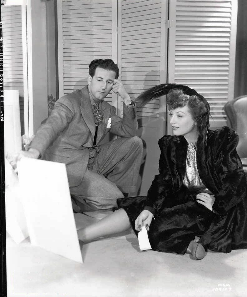 May 16, 1939. On the set of 'The Women' with designer Adrian.