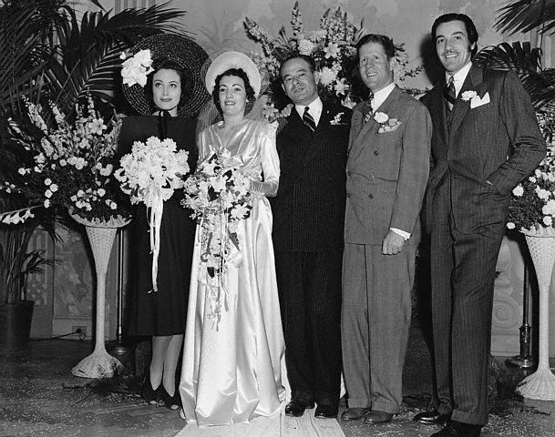 February 13, 1940. Joan is maid of honor at photog Hyman Fink's wedding. Cesar Romero at far right.