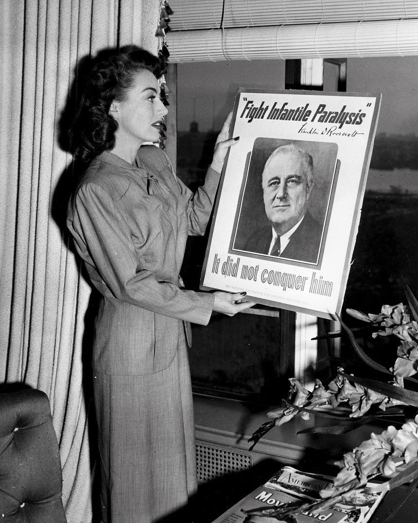 1945. With a March of Dimes poster featuring FDR.