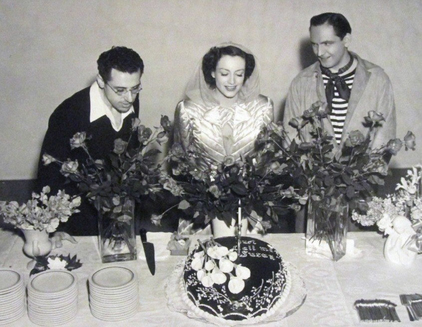 1940. Joan's birthday on the set of 'Susan and God,' with George Cukor, Fredric March, and 'Just Call Me Susan' cake.