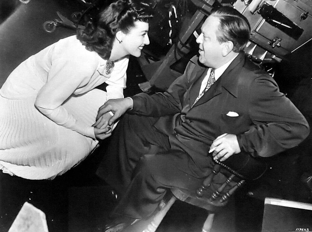 1941. On the set of 'When Ladies Meet' with director Robert Z. Leonard.
