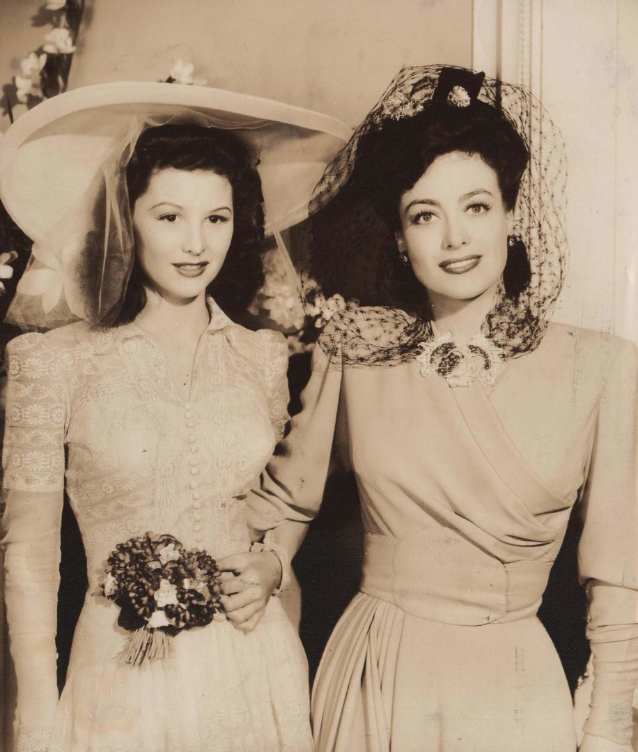 1942. On the set of 'They All Kissed the Bride.' With Shirley Patterson.