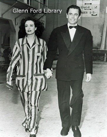 1942. On the set of 'They All Kissed the Bride.' With Glenn Ford.