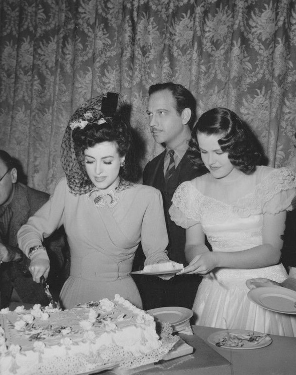 1942. On the set of 'They All Kissed the Bride' with Melvyn Douglas and Helen Farriah.