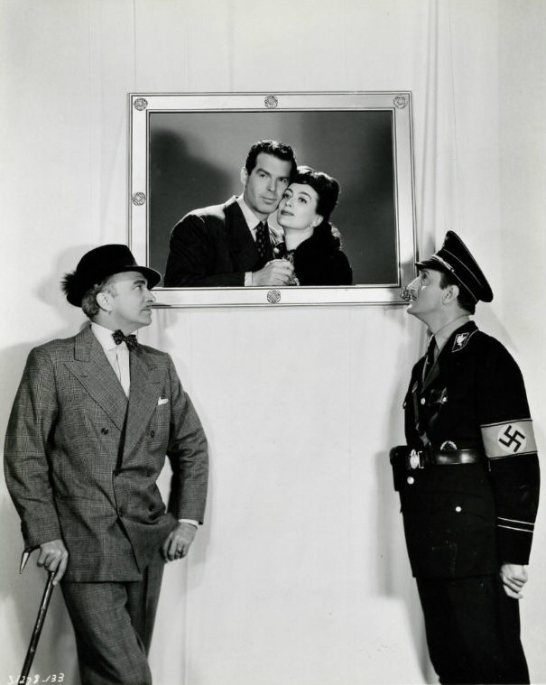 1943. 'Above Suspicion.' Conrad Veidt and Basil Rathbone with picture of Joan/MacMurray.