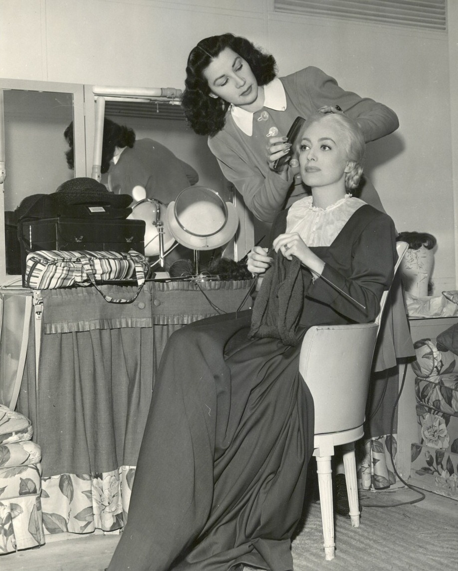 1943. On the set of 'Above Suspicion' with hairdresser Gertrude Kuhn.