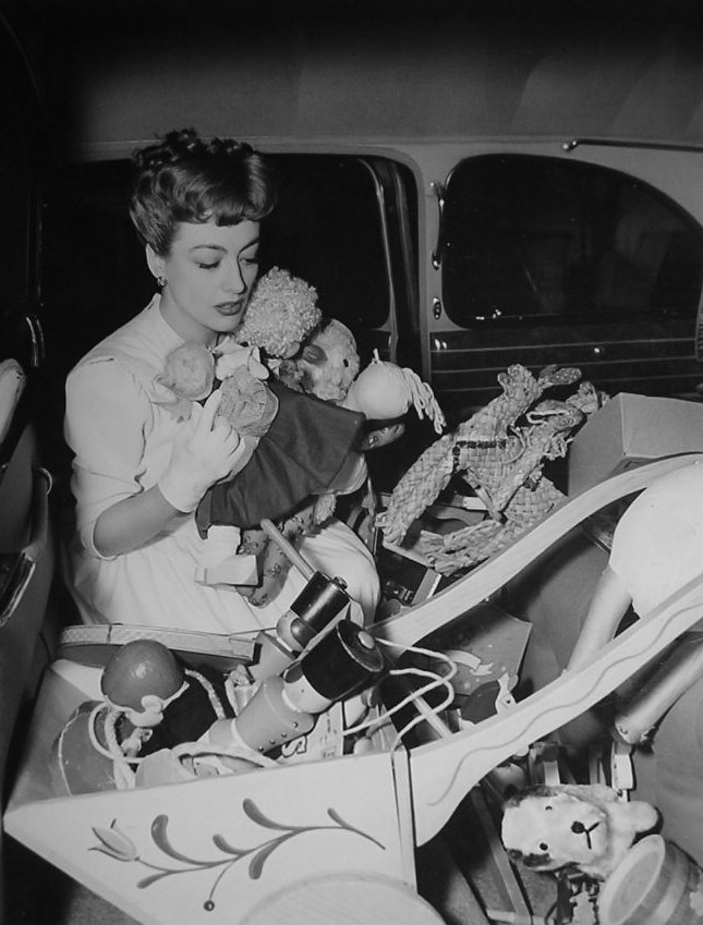 1943. Joan delivering charity gifts for Christmas.