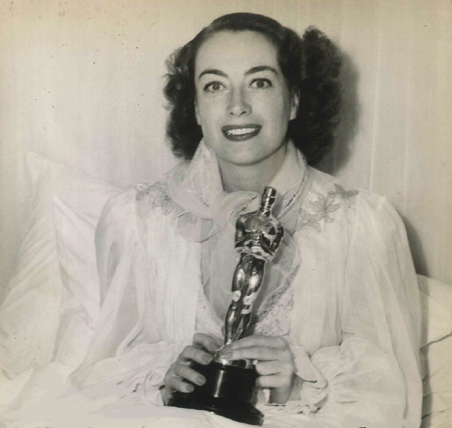 1946. At home, holding her new Oscar for 'Mildred Pierce.'