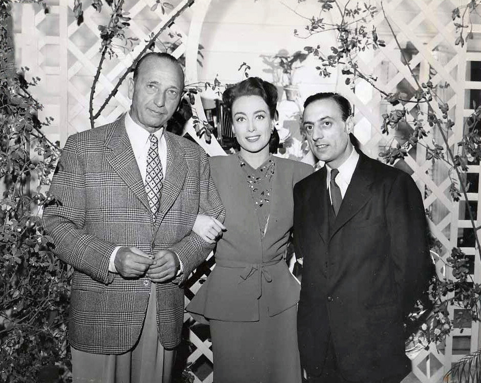 February 1945. On the set of 'Mildred Pierce' with director Curtiz and French Underground publisher Stephen Pizella.