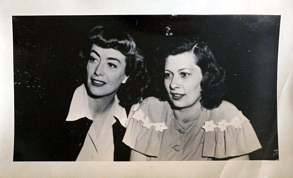 June 1946. On the set of 'Possessed' with fan club president Edith Clemens.