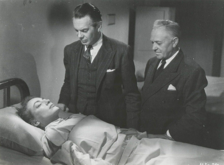 1947. 'Possessed' film still with Raymond Massey.