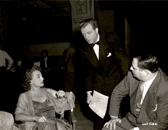 1947. On the set of 'Possessed' with Van Heflin and unknown.