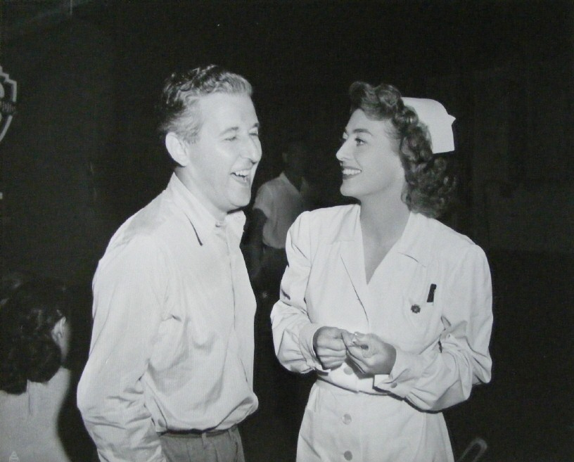 1947. On the set of 'Possessed' with director Curtis Bernhardt.