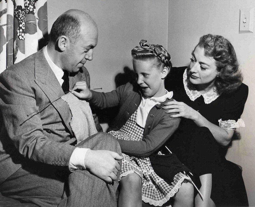 With director Preminger and daughter Tina on the 'Daisy Kenyon' set.