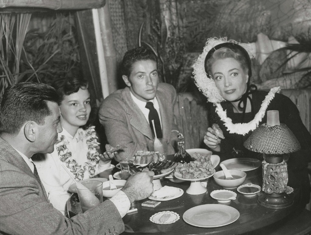 1948 at Don the Beachcomber with director Irving Reis, goddaughter Joan Evans, and Farley Granger.