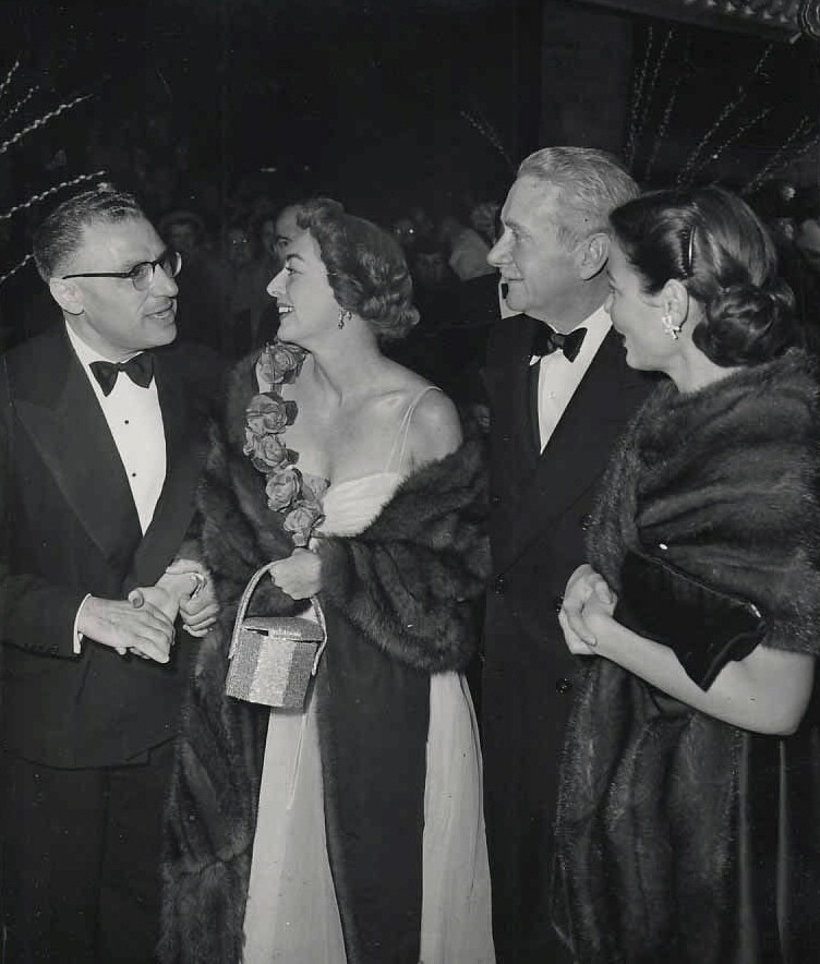 1949. At a club with George Cukor, Clifton Webb, and Gene Tierney.