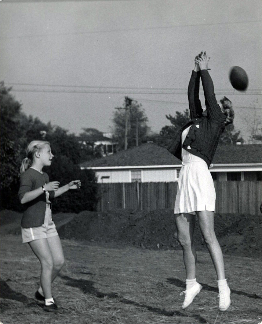 1949. Joan and Christina playing football.