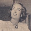 In unknown magazine, 1949, in a dress she knitted herself.