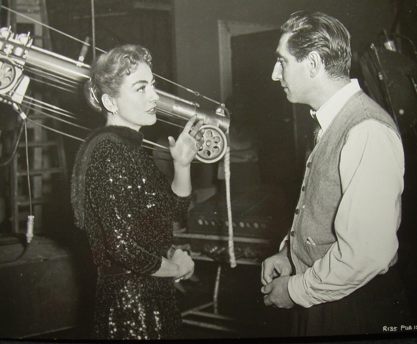 1957. On the set of 'Esther Costello' with director David Miller.