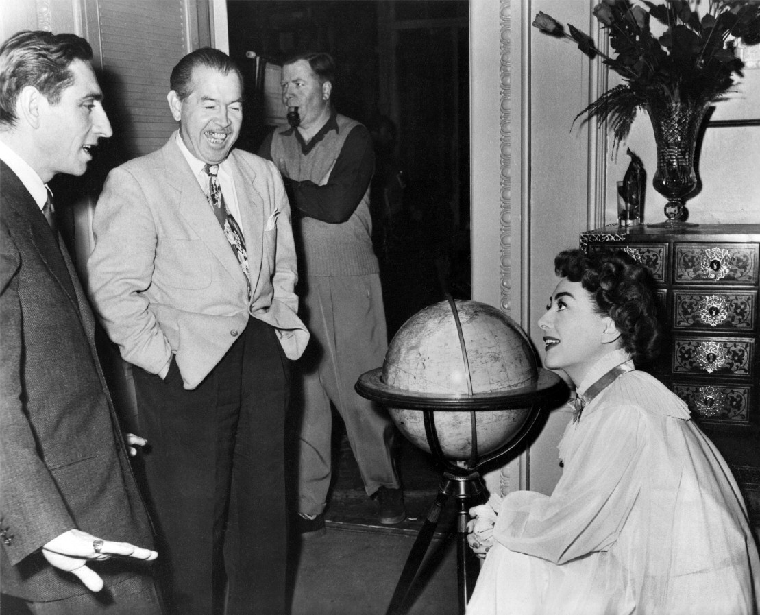 1952. On the set of 'Sudden Fear' with director David Miller, left, and columnist Jimmy Starr.