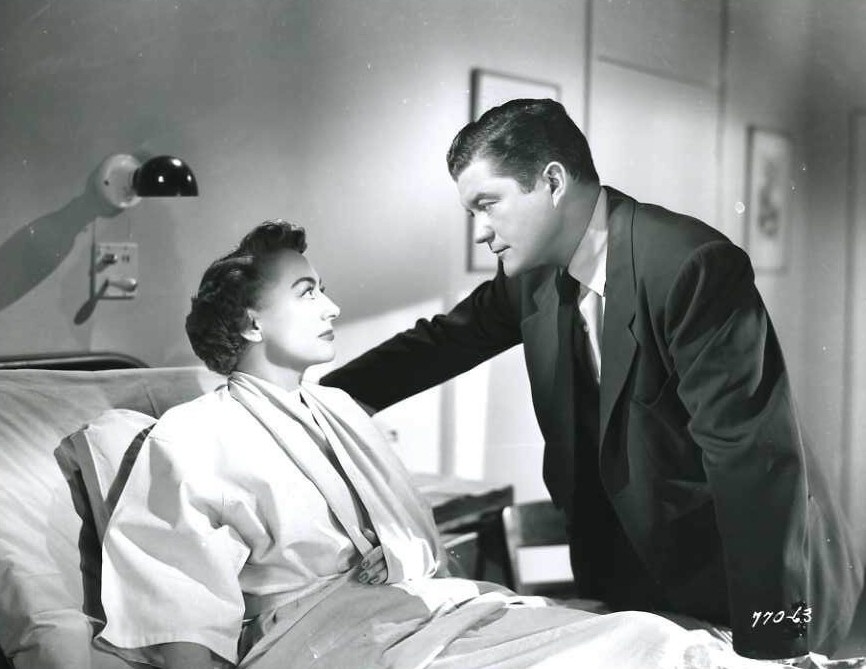 1952. Film still from 'This Woman Is Dangerous.' With Dennis Morgan.