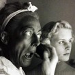 1953. Making up in blackface with Christina looking on. Shot by Sanford Roth.