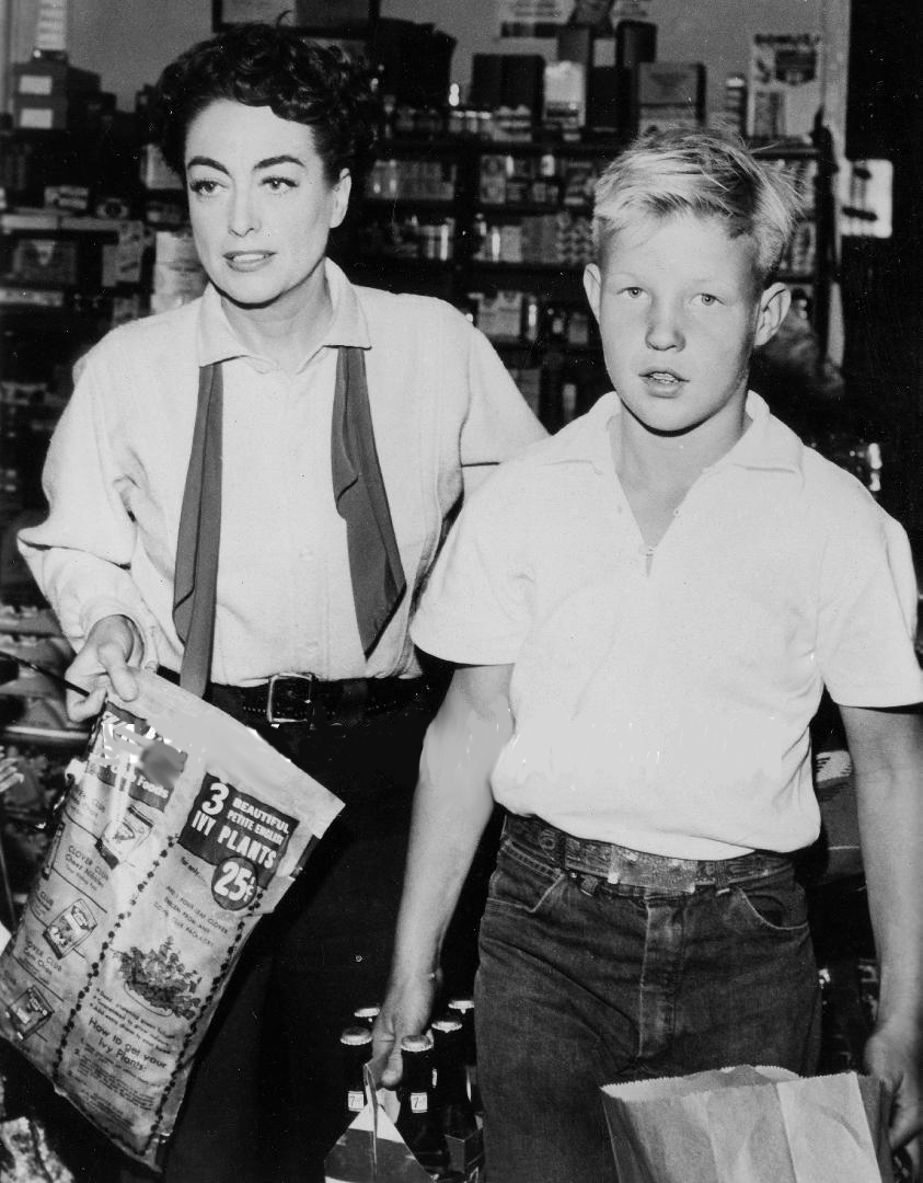 1954. On the set of 'Johnny Guitar' with son Christopher.