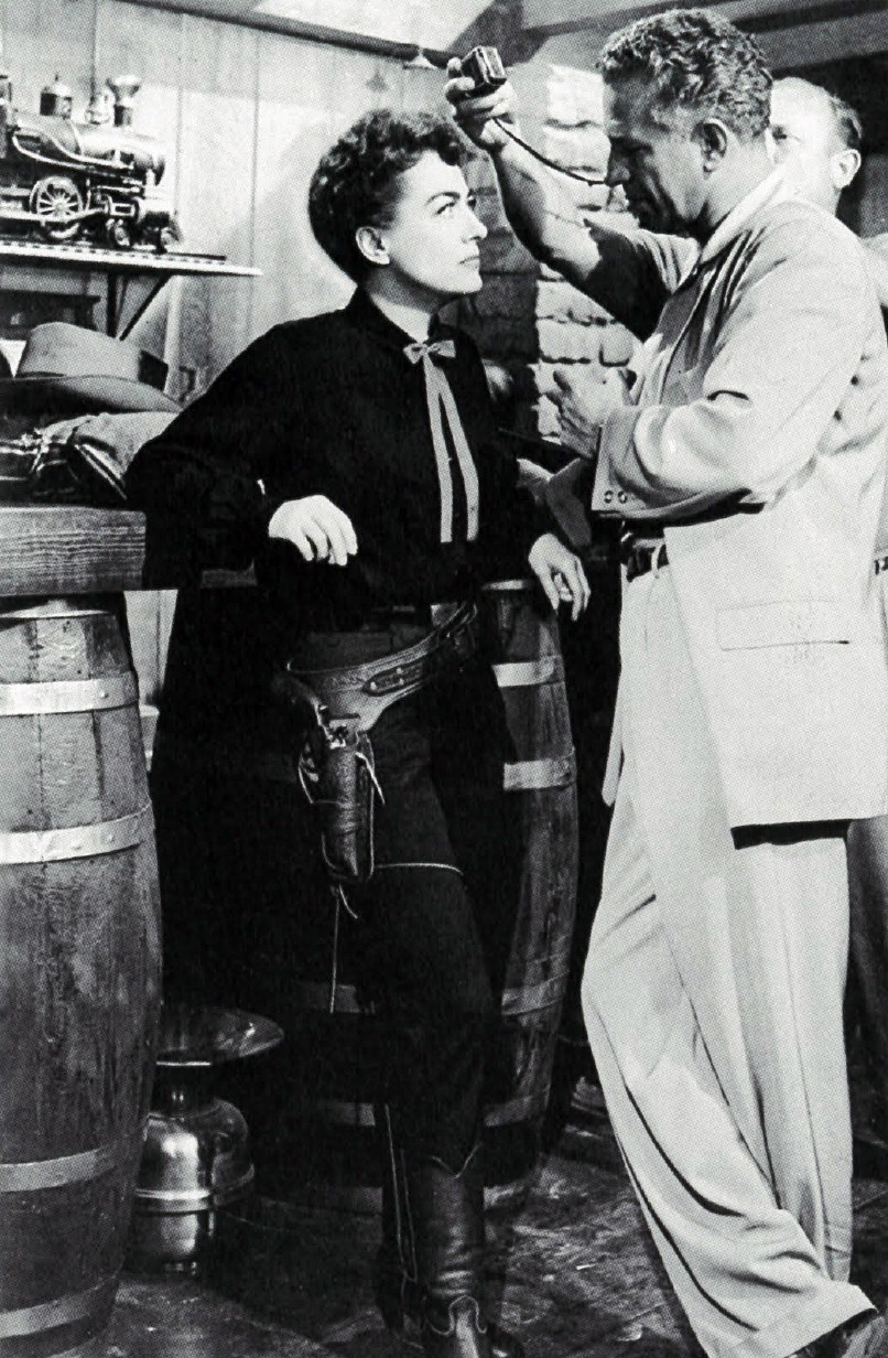 1954. On the set of 'Johnny Guitar' with director Nicholas Ray.