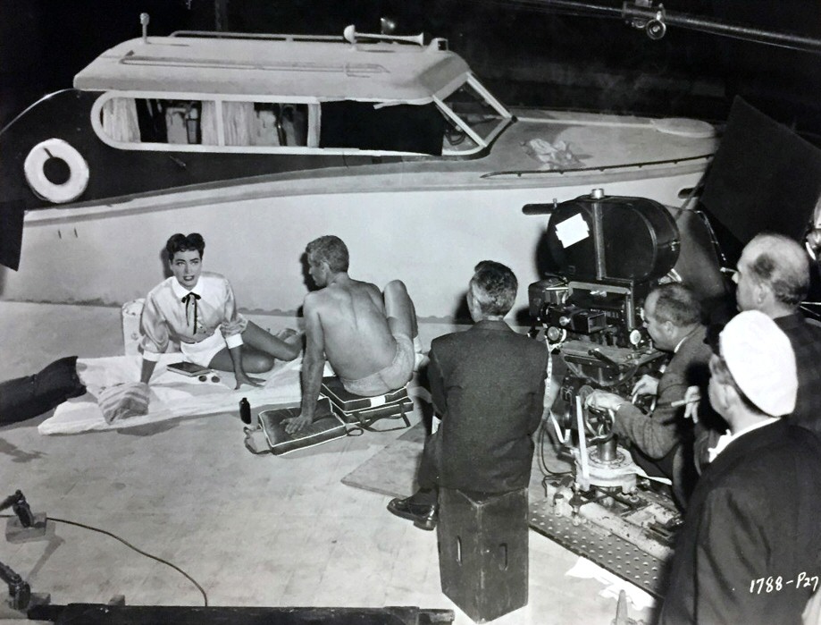 1955. On the set of 'Female on the Beach' with Jeff Chandler and crew.