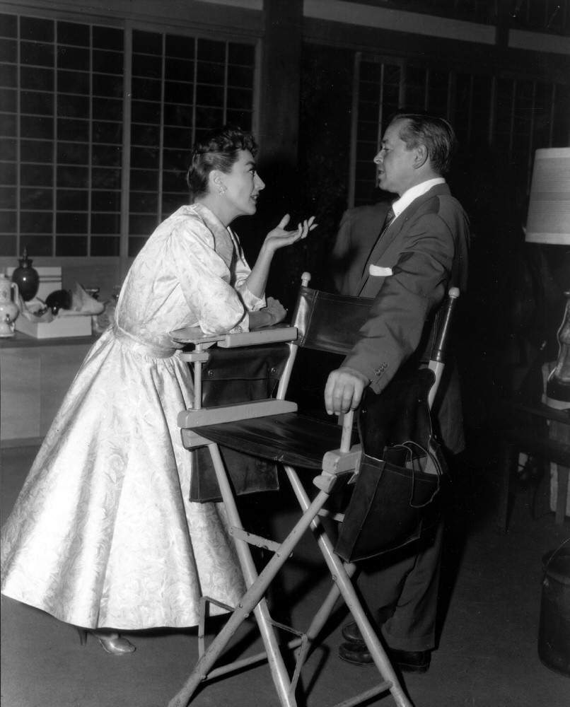 1955. On the set of 'Female on the Beach' with director Joseph Pevney.