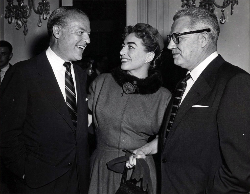 May 1955. At a Columbia party in Joan's honor with company exec, left, and husband Al Steele.